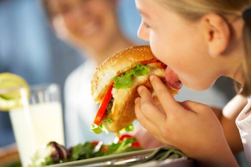 Girl eating big hamburger